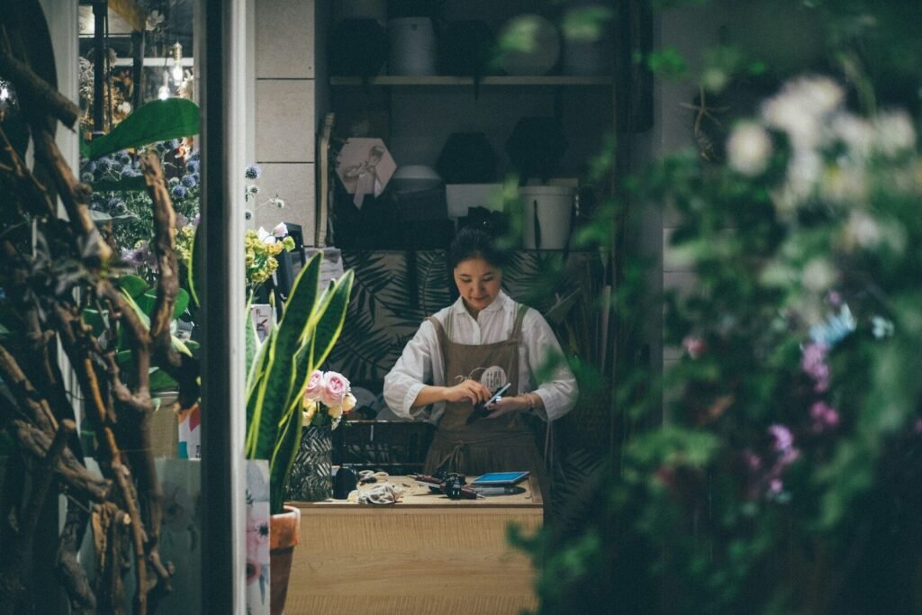 Small business owner standing beside a table in a shop, illustrating AI tools for small businesses