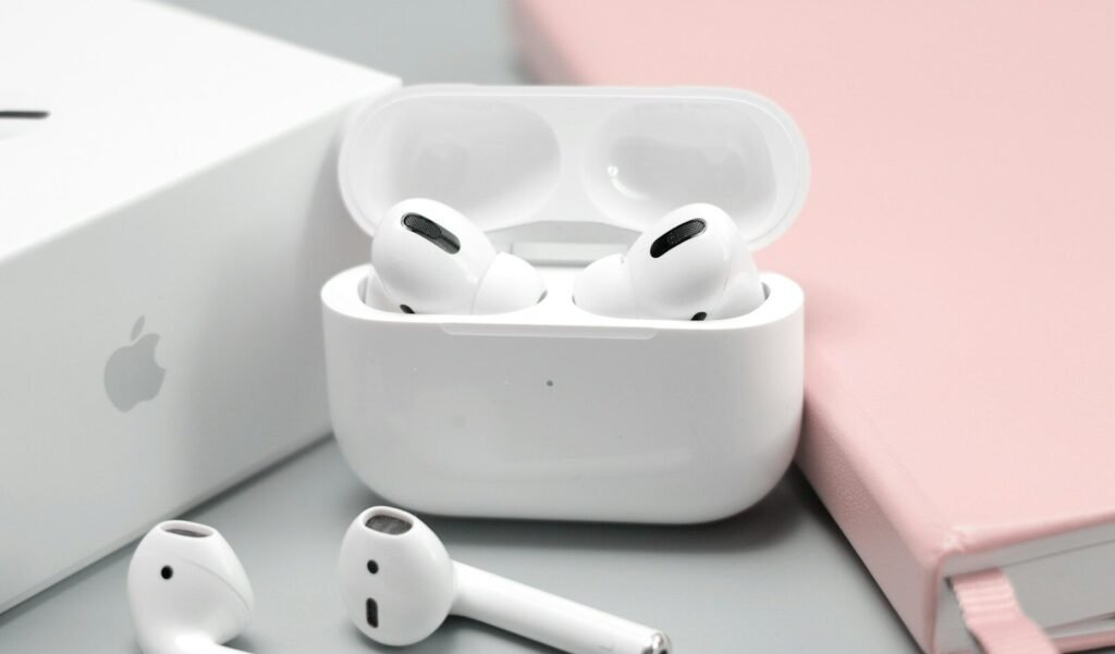 White wireless earbuds in an open charging case, illustrating budget wireless earbuds in 2026