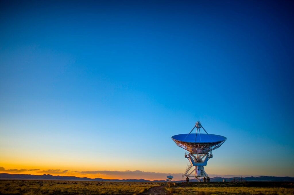 Satellite dish in a rural field at sunset, illustrating satellite internet for rural connectivity